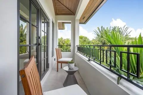 Black balcony railing overlooking tropical landscaping