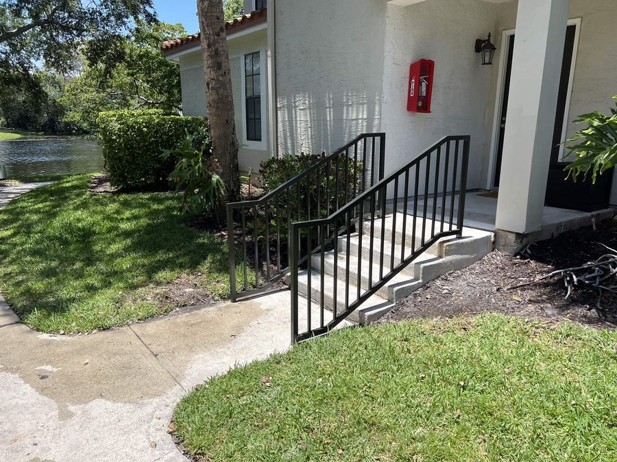 Black steel handrail on front entry steps