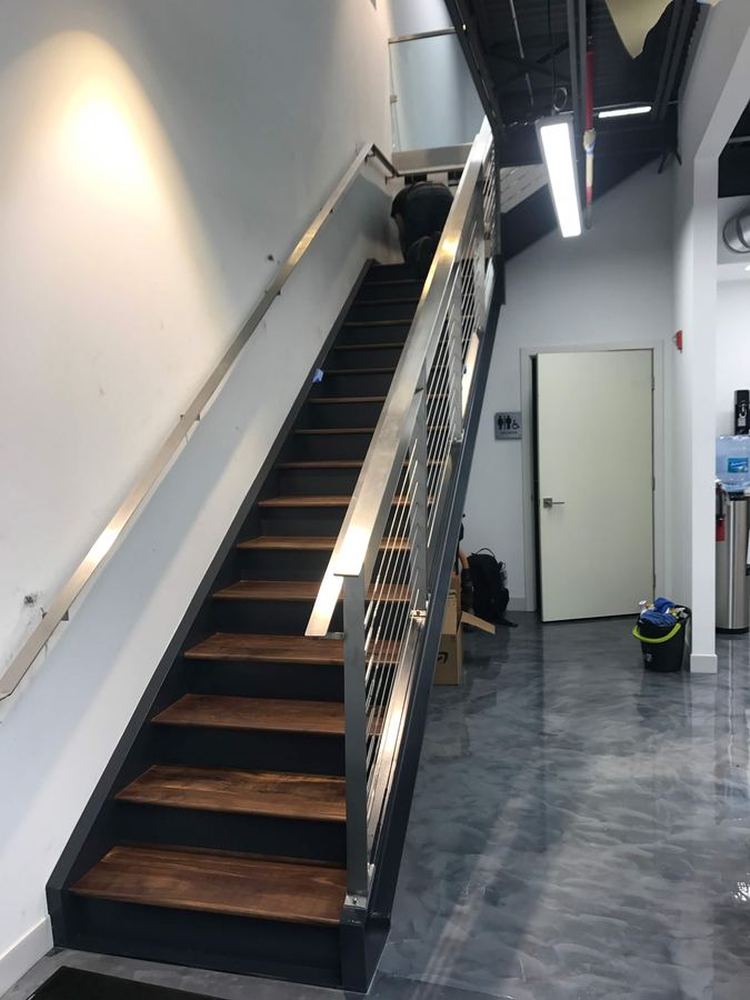Open riser staircase with wood treads and cable railing